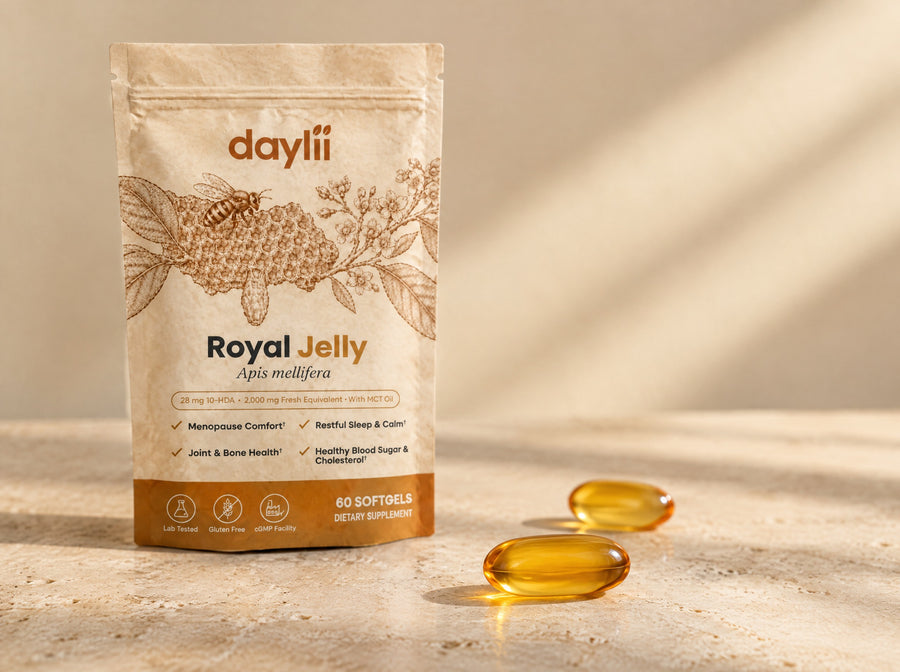 Close-up of a royal jelly softgel glowing with golden oil beside the pouch